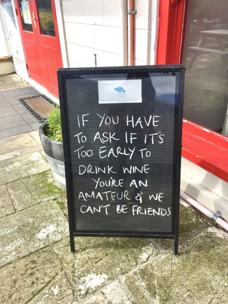 Sign that says " If you have to ask if it's too early to drink wine you're an amateur and we can't be friends"