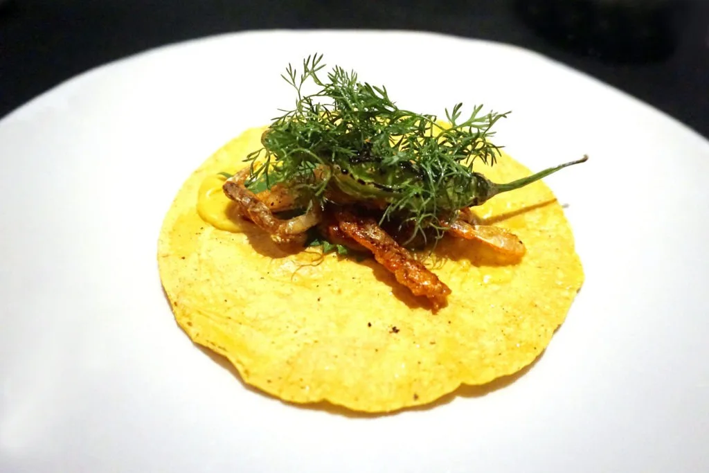 Soft shell crab taco with a shishito pepper and greens