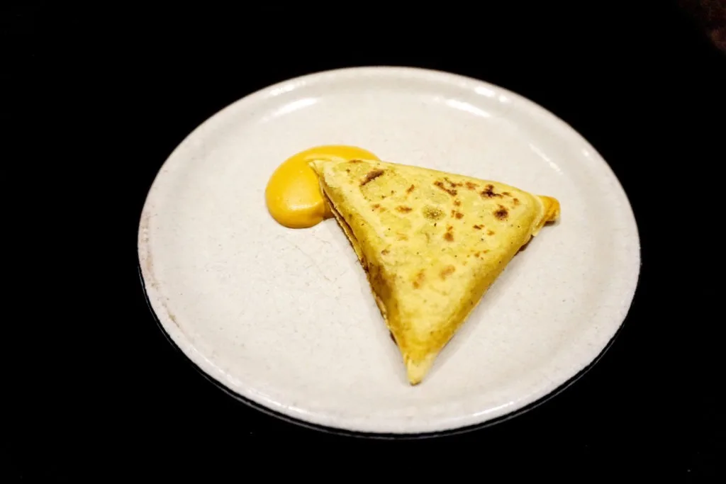 Tatela on a plate with yellow sauce