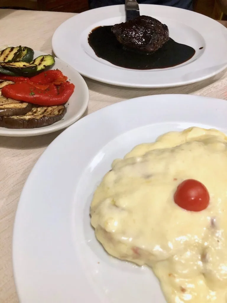 Milanese covered in cheese with grilled vegetables and veal cooked in balsamic vinegar