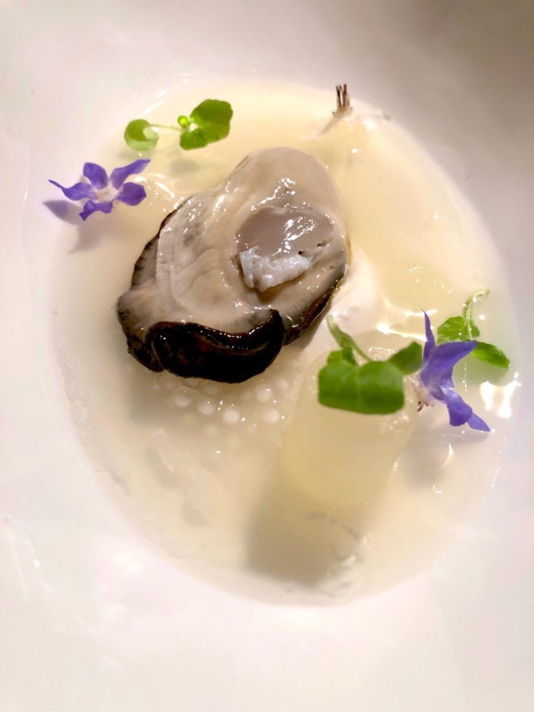 Mirazur oyster with pear gelee, tapioca, and borage flowers